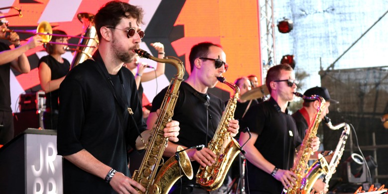 Horn section playing a gig on stage